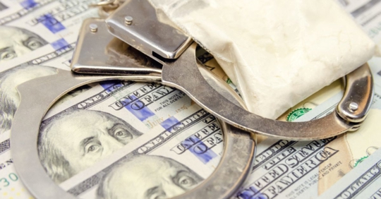 handcuffs, dollar bills, and drugs